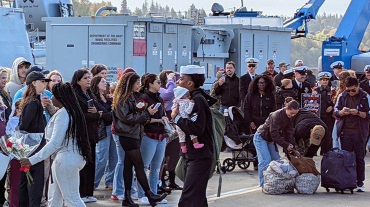 USS Gridley sailor holding newborn